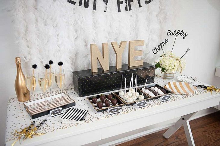 DIY New Year Table Decoration with White Flowers Chocolates and Champagne
