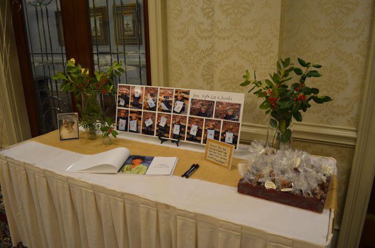 Elegant 80th birthday guest table decor with picture frame and plants