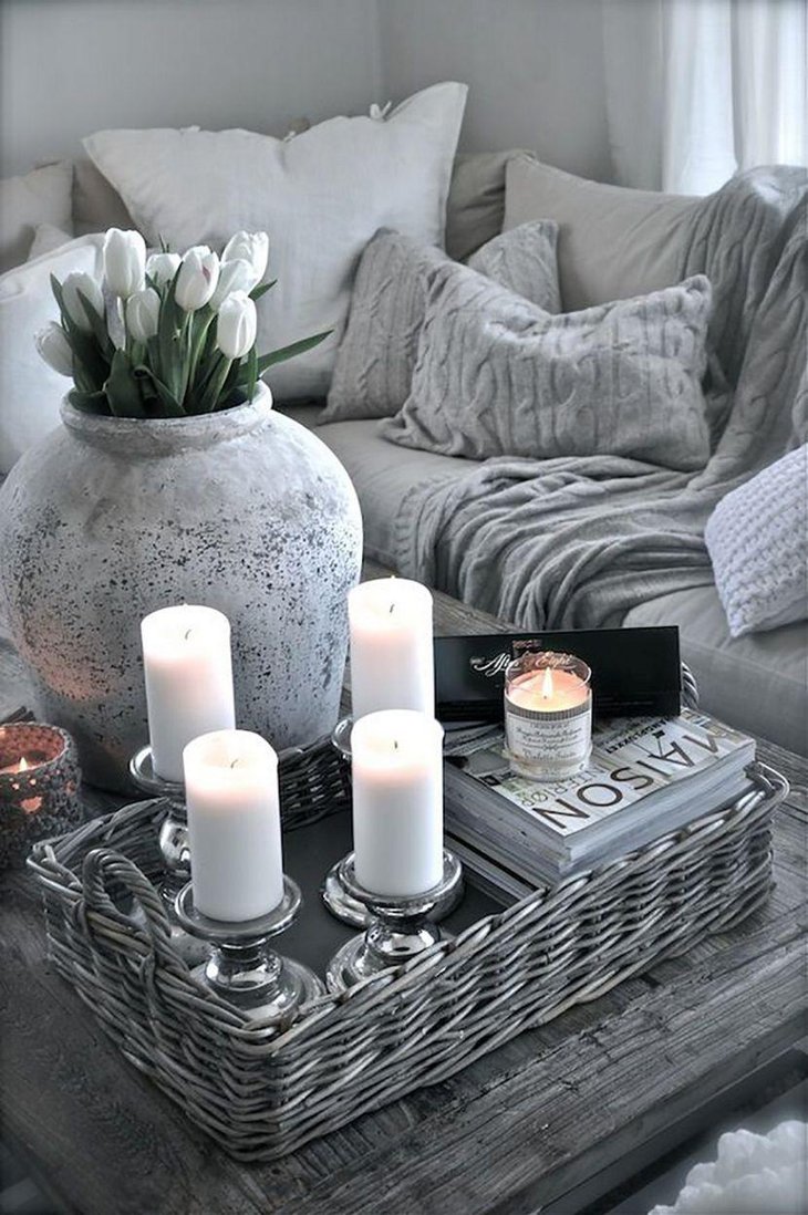 Elegant candleholders and rattan tray decor on coffee table