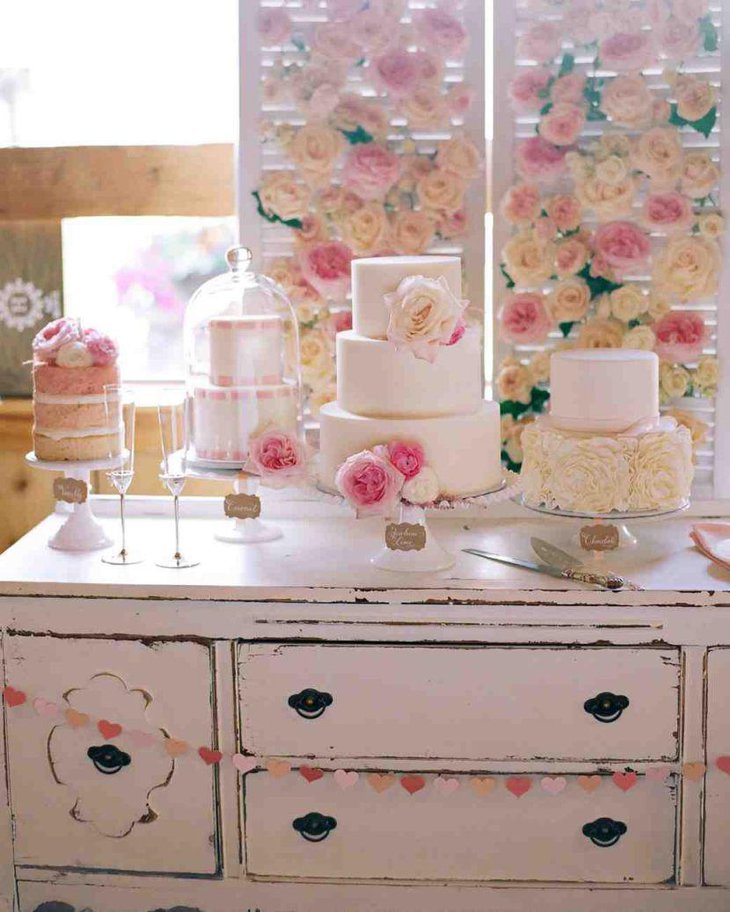 Elegant European dessert table with pink and white cake display