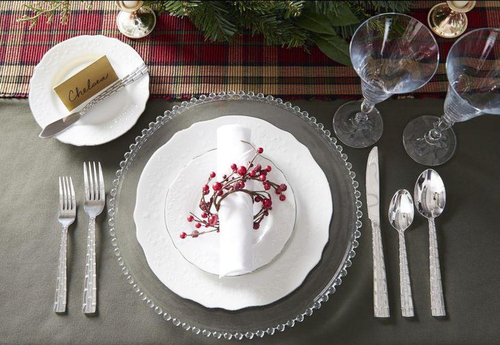 Elegant formal party table setting with crisp white napkin wrapped by a beaded twine thread and taper candles