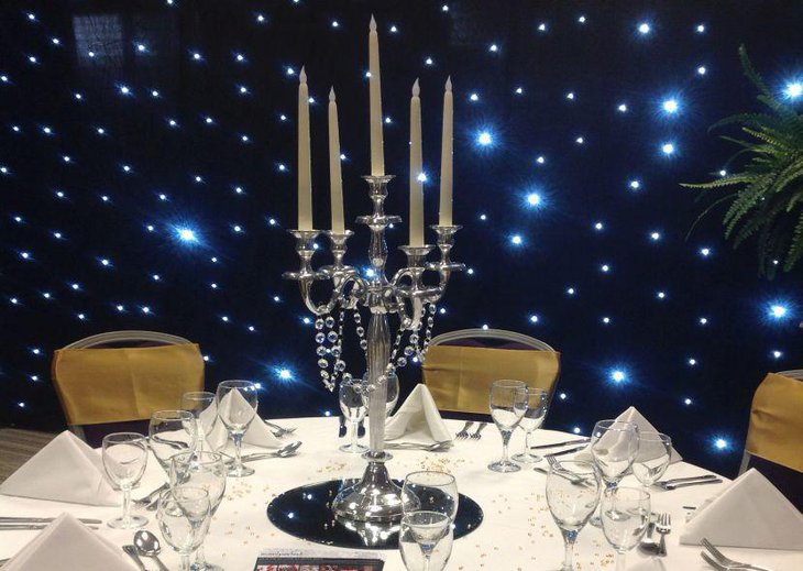 Exotic party table setting with a gorgeous candelabra with crystal garland