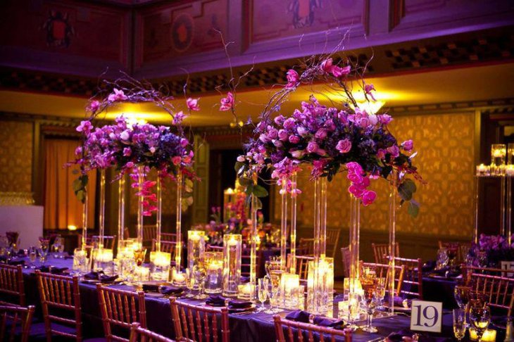 Exotic purple floral decorations on wedding reception table