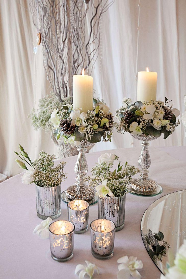 Exquisite winter wedding table decor with silver votives vases and candle holders