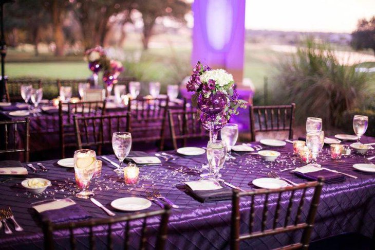 Fabulous outdoor purple themed wedding reception table decor