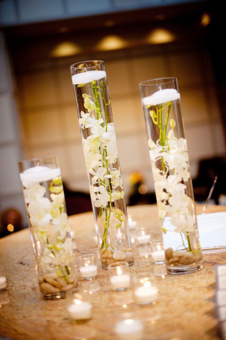 Floating White Orchids In Hurricane Vases As Wedding Table Centerpiece