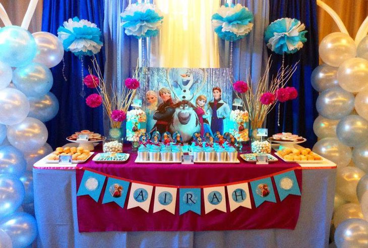 Floral decor on Frozen themed birthday table for kids