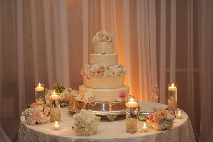 Flower and candle decor on wedding cake table