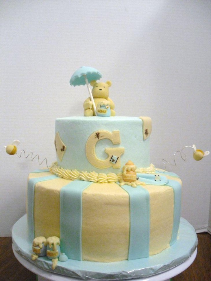 Frosted buttercream Winnie The Pooh baby shower cake decoration with honey pots