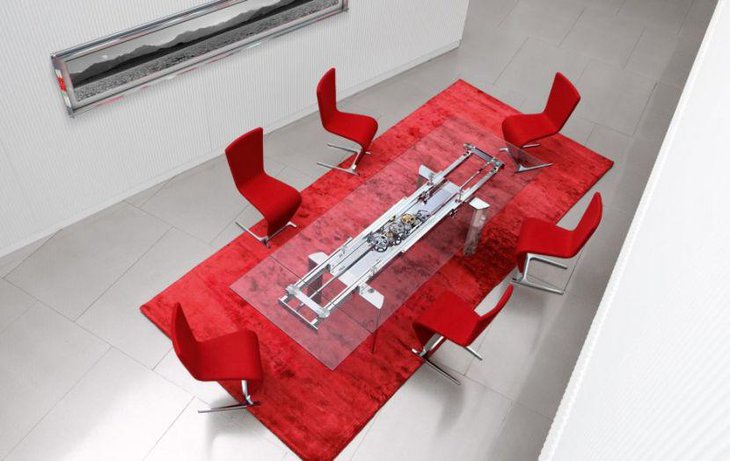 Futuristic transparent glass top dining table with metal finish