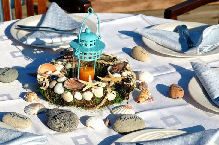 Garden party table decor with shells and blue lantern centerpiece