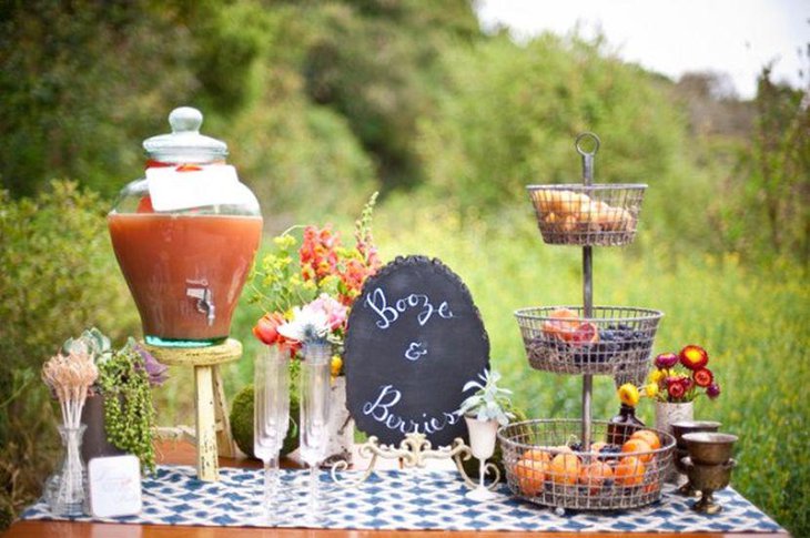 Garden party table setting with fruit punch bowl and berries