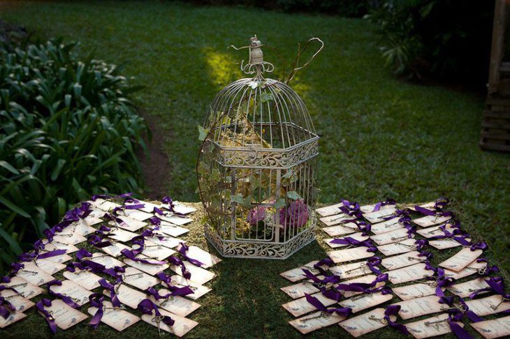 Garden wedding escort card table with purple theme