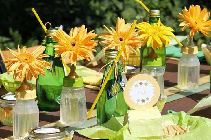 Girl baby shower table decor with bright yellow flower centerpieces