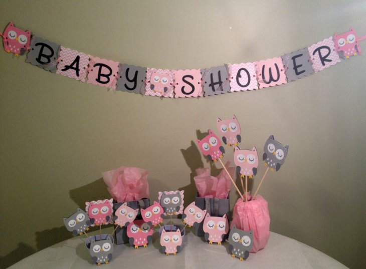 Girl baby shower table decorated with owl centerpieces