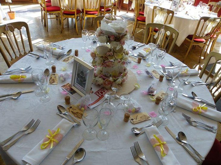 Glam floral and candle centerpiece on a wedding breakfast table