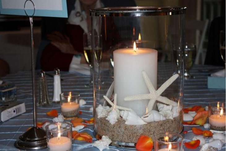 Glass candle centerpiece with sand shells and starfish