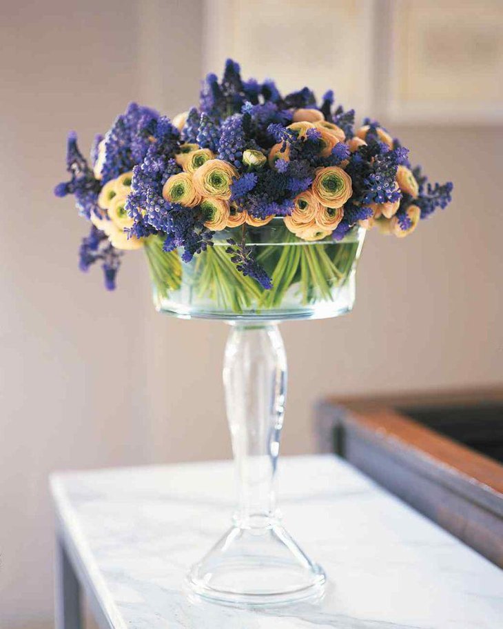 Glass compote floral centerpiece on spring table