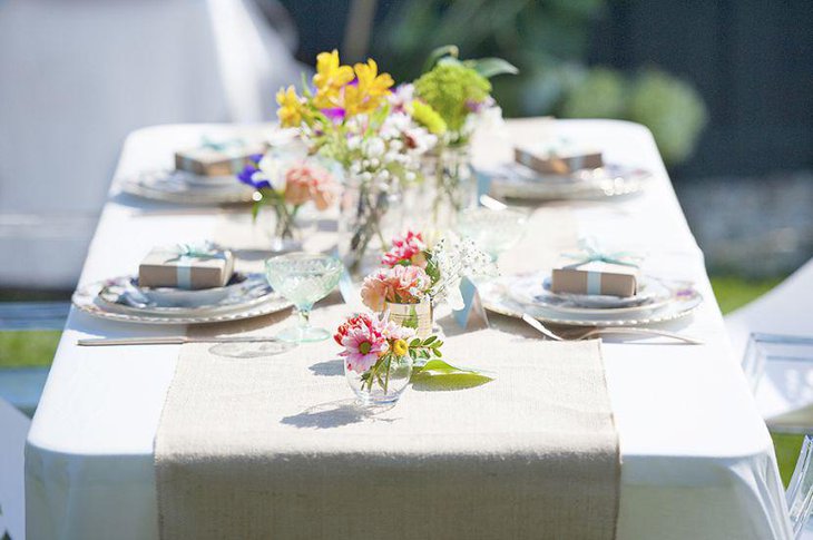 Glass vase decorations on garden party table
