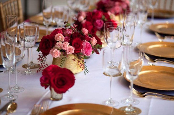 Golden floral vases and plates for winter wedding table