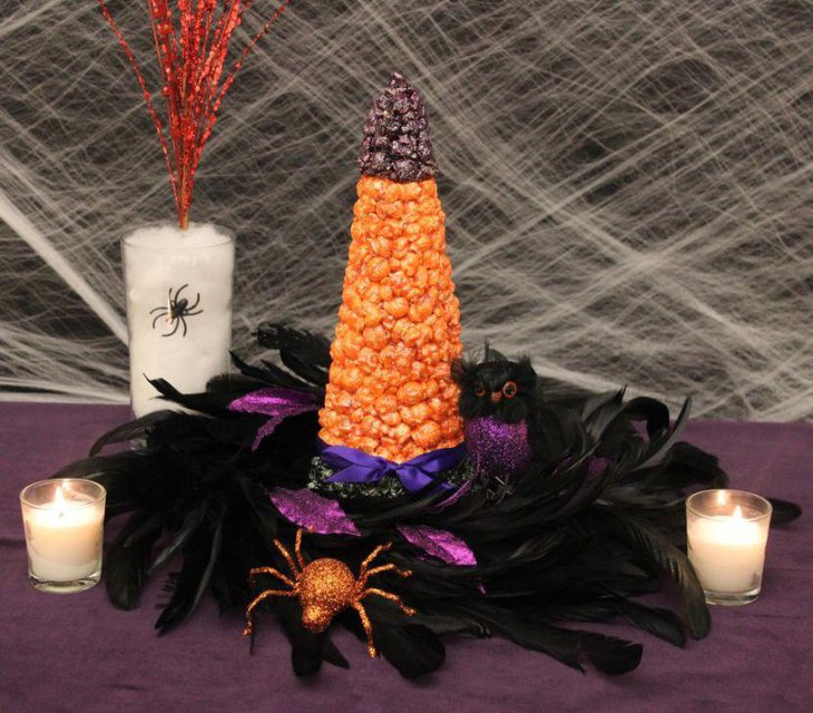 Golden spider and cute black and purple coloured bird centerpiece for Halloween table