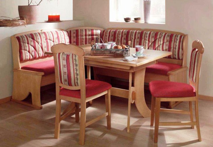 Gorgeous breakfast nook with red wooden sofa and chair and wooden table