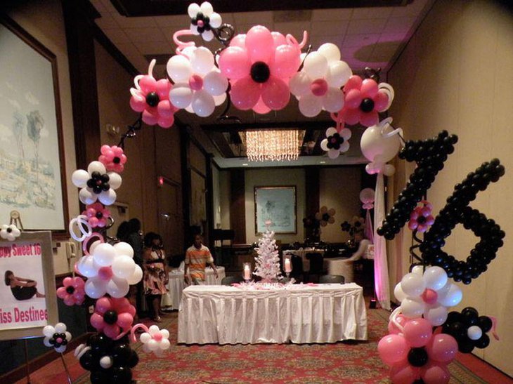 Gorgeous centerpiece on a white and pink toned sweet 16 birthday table