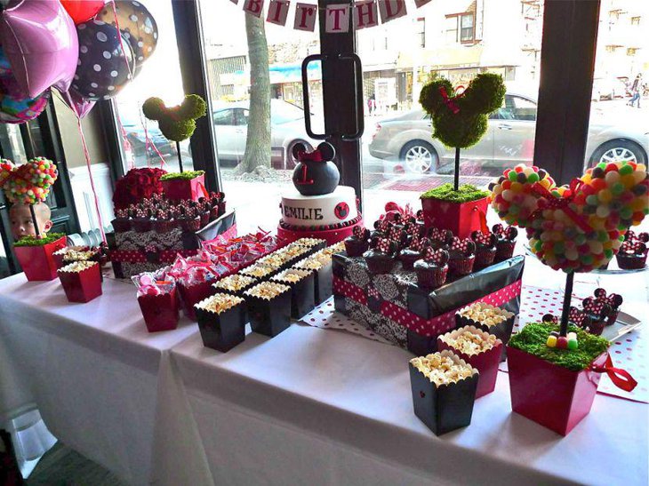 Gorgeous DIY Minnie Mouse topiary centerpiece on candy buffet table