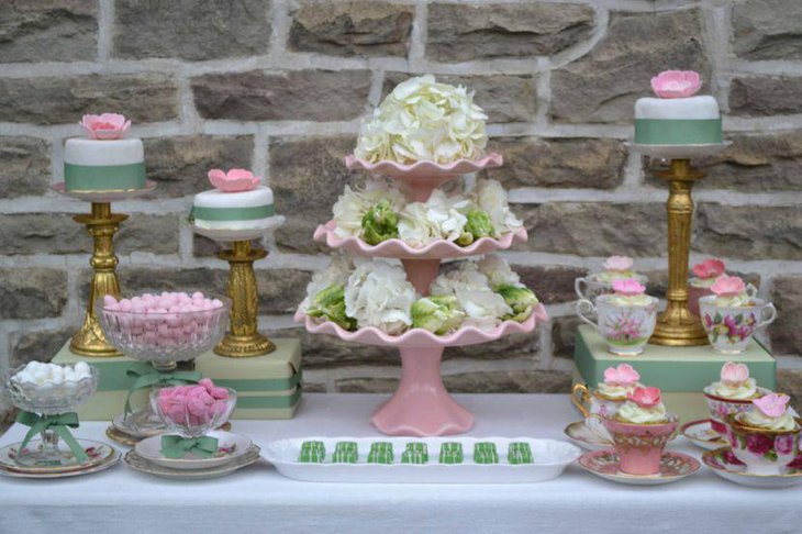 Gorgeous European dessert table decoration using tiered floral centerpiece and pink accents