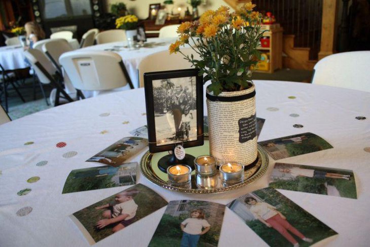 Gorgeous flowers and picture frame decor on 80th birthday table