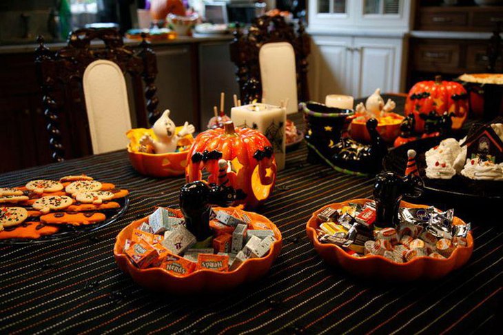 Gorgeous Halloween table decor with candles and candle lit pumpkins