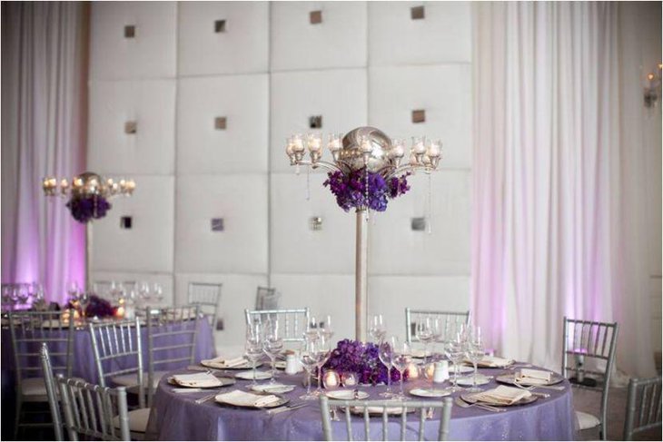 Gorgeous silver candleholder and violet floral arrangement for adult party table
