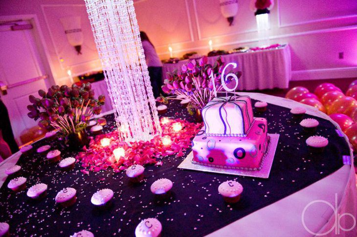Gorgeous sweet 16 birthday table with a cute pink cake and cupcakes