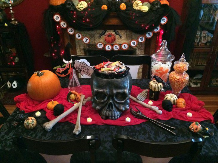Gothic styled Halloween table with skull candy holder bones and pumpkins