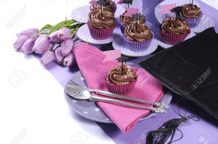 Graduation Day party table decoration with purple polka dot cupcake stands