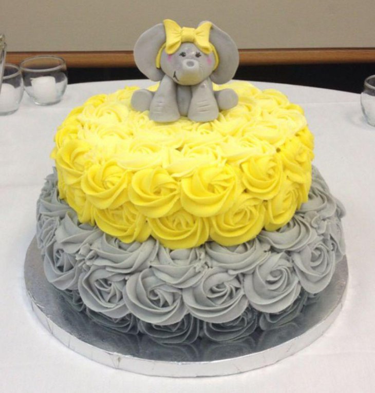 Grey and yellow rose cake with elephant on top for baby shower