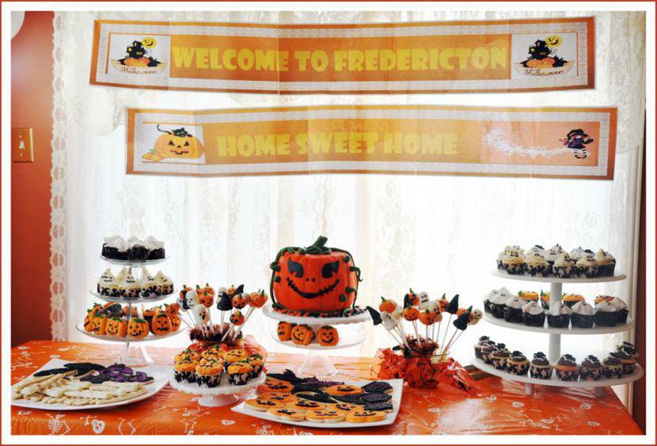 Halloween party dessert table with Jack O Lantern cake and goodies