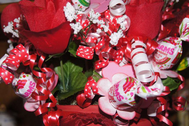 Homemade floral Valentine centerpiece with ribbons and toffies