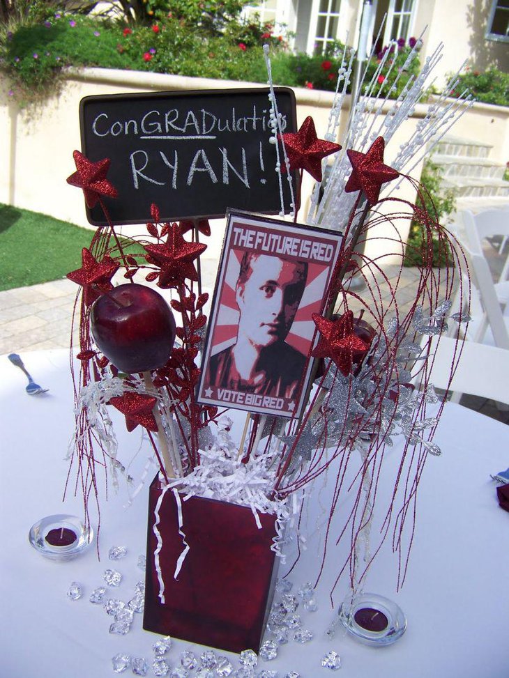 Homemade graduation box centerpiece with silver sticks and red stars