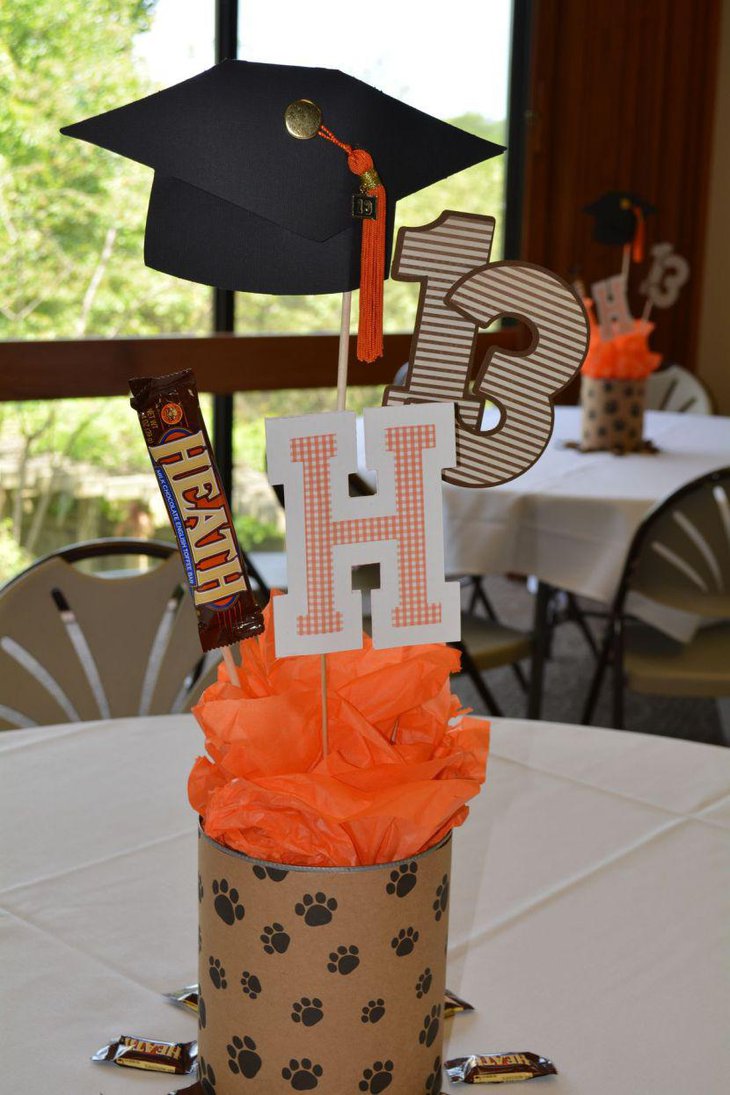 Homemade graduation table centerpiece with paw print wrapping