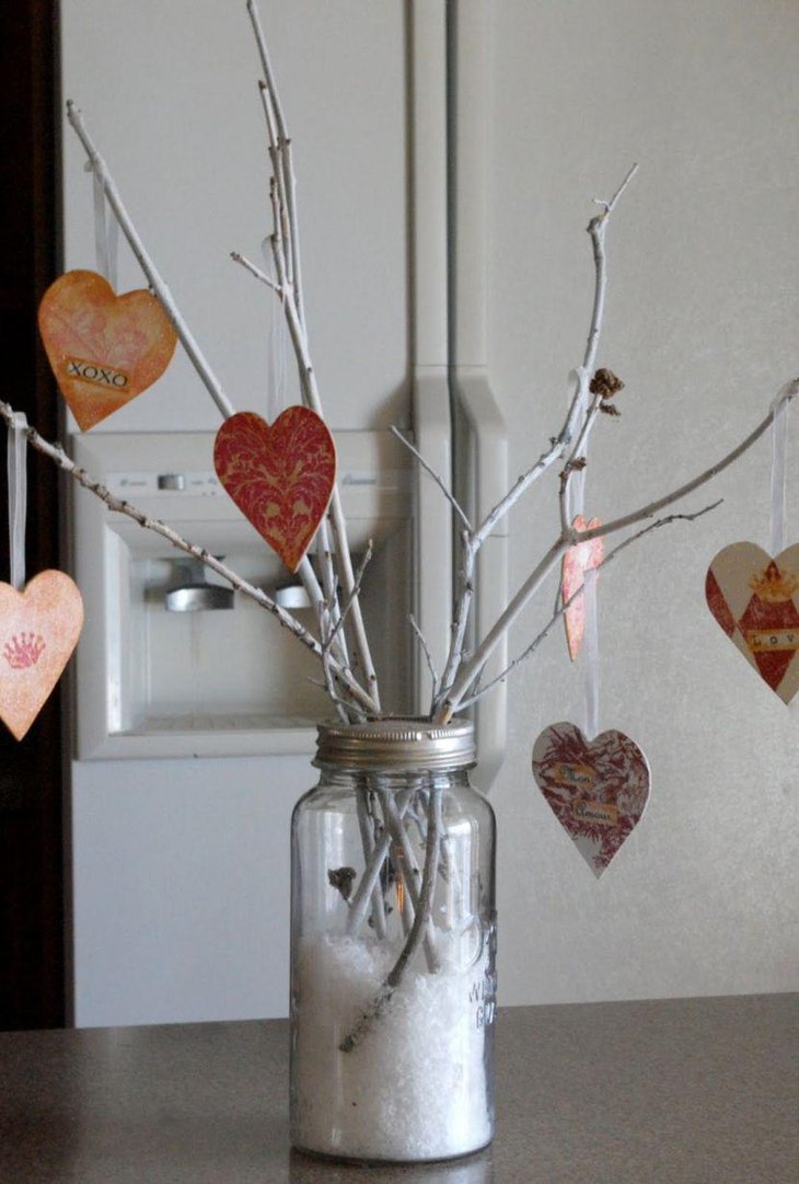 Homemade Valentines jar with branches and paper hearts centerpiece