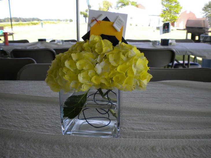Homemade yellow floral graduation table centerpiece