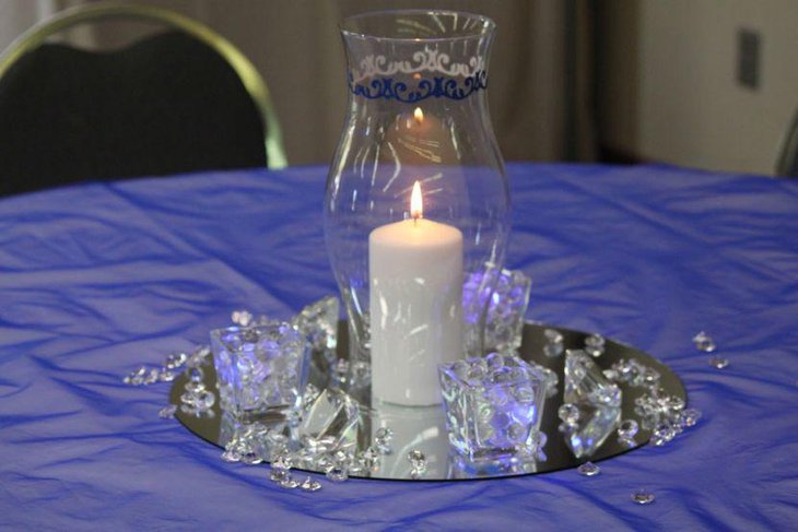 Impressive wedding party table setting with hurricane vase candle and crystals