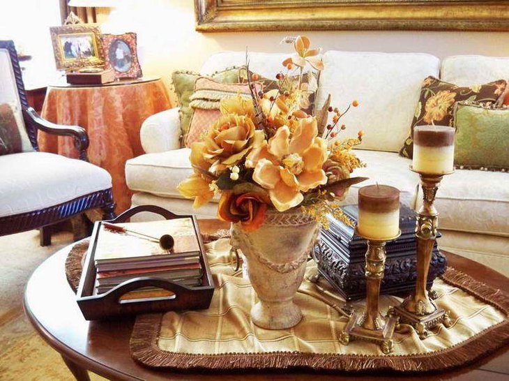 Innovative coffee table decor with brass candleholders and flower vase