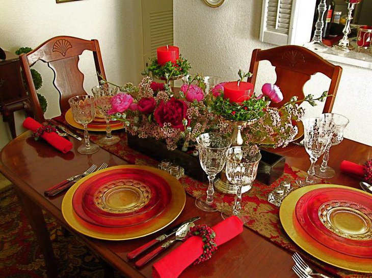 Inspirational formal dinner party table setting in red and golden tones