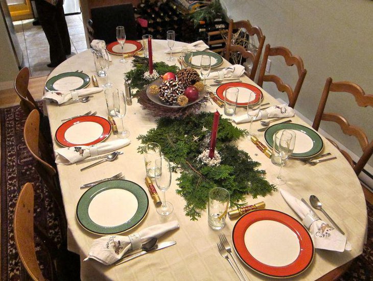Inspiring Christmas table setting with pines and greens