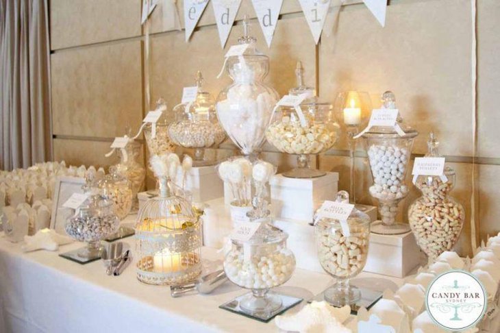 Ivory and white candy table at a wedding event