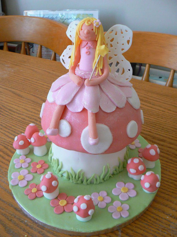 Lovely pink themed fairy on mushroom cake for girls birthday party