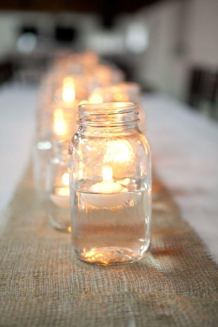 Mason jar candle centerpieces on wedding table