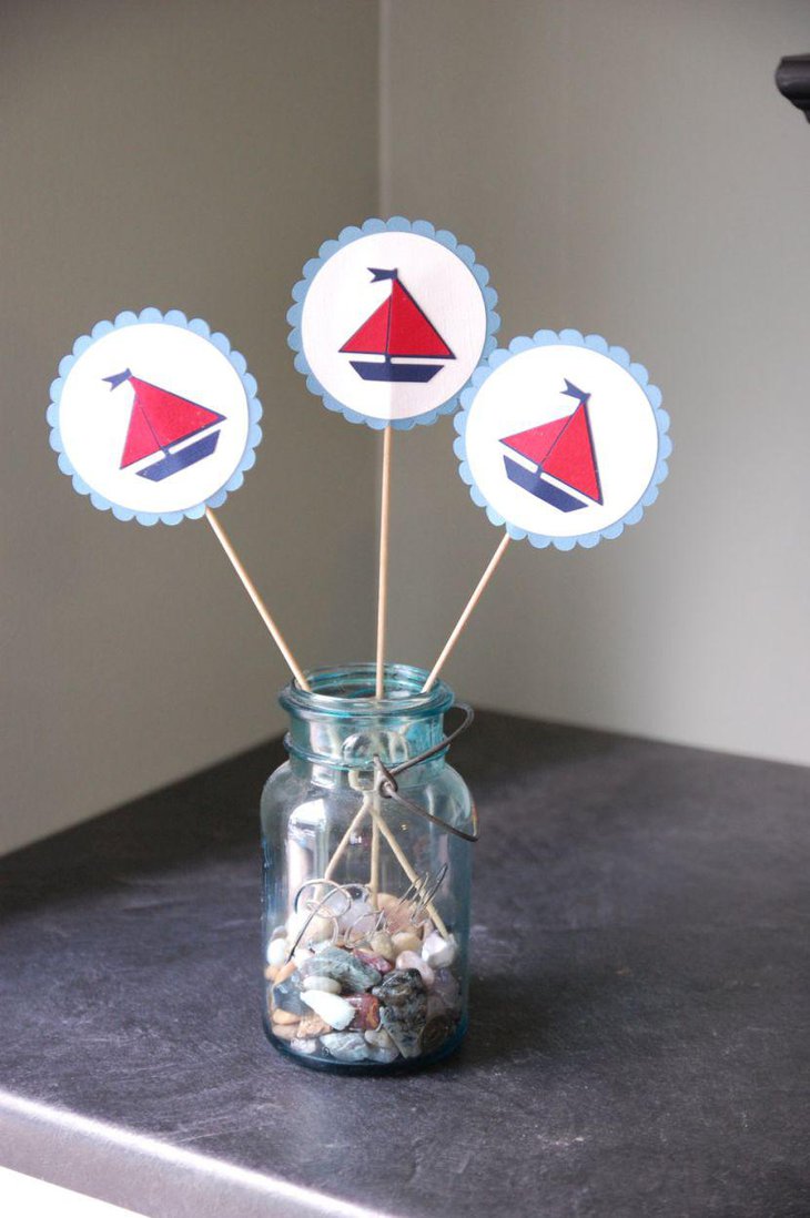 Mason jar centerpiece with red and blue sailboat sticker straws on nautical baby shower table